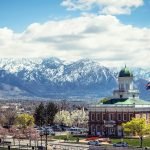 A picturesque view of Salt Lake City's historic buildings against the snow-capped mountains.