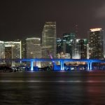 Stunning nighttime view of the illuminated Miami skyline and bridge.